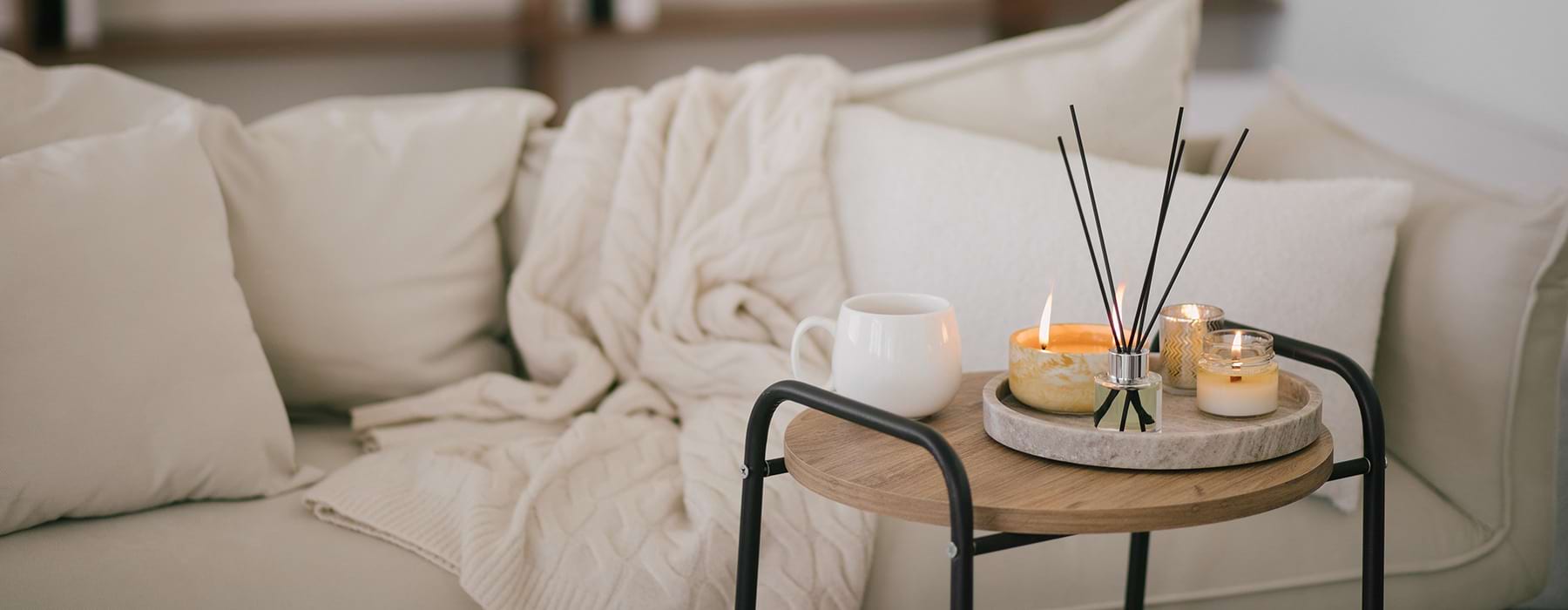 small table by a couch with candles on it